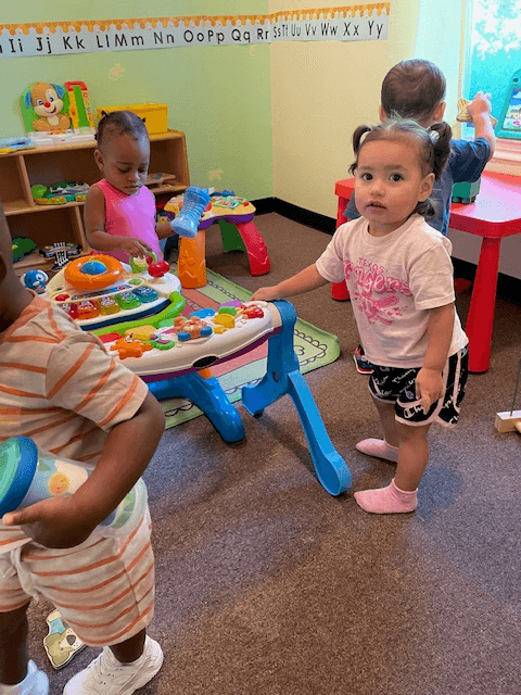 Toddlers exploring toys in the playroom
