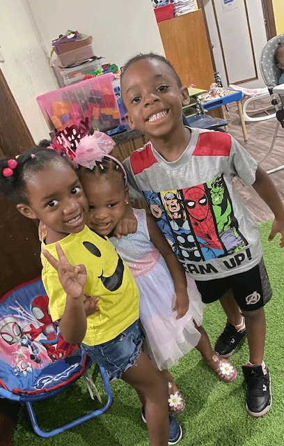 Smiling friends posing together at the center