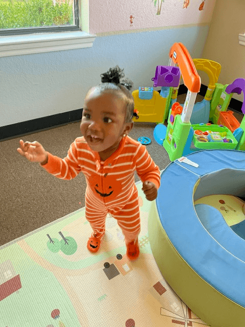 Happy toddler playing in the activity room
