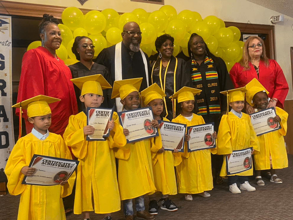 Graduates and staff celebrating with certificates
