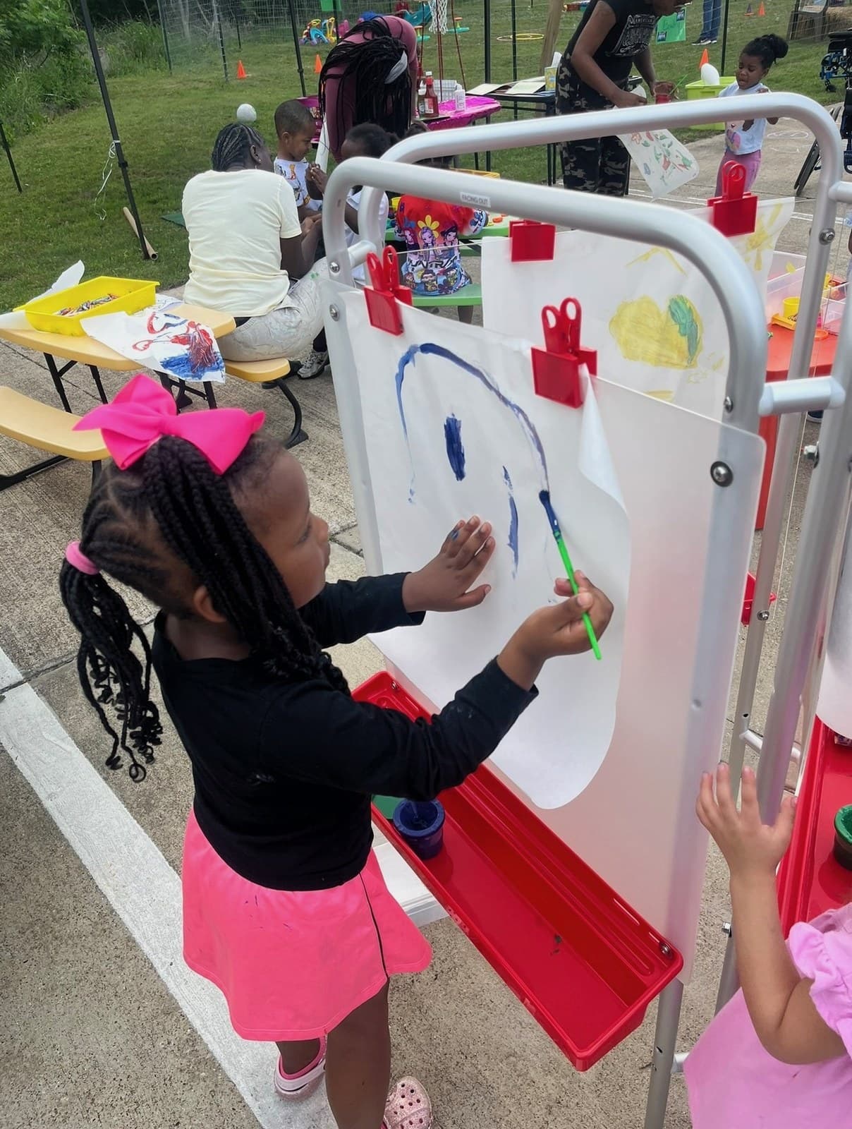 Painting at the easel during outdoor art time