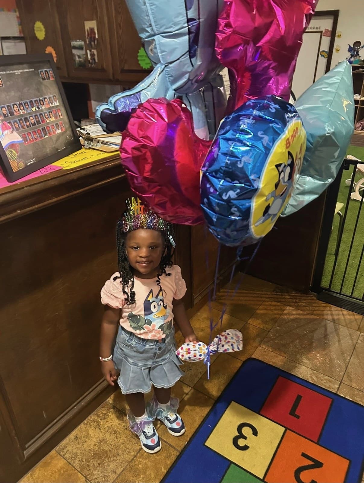 Celebrating a birthday with balloons and a crown